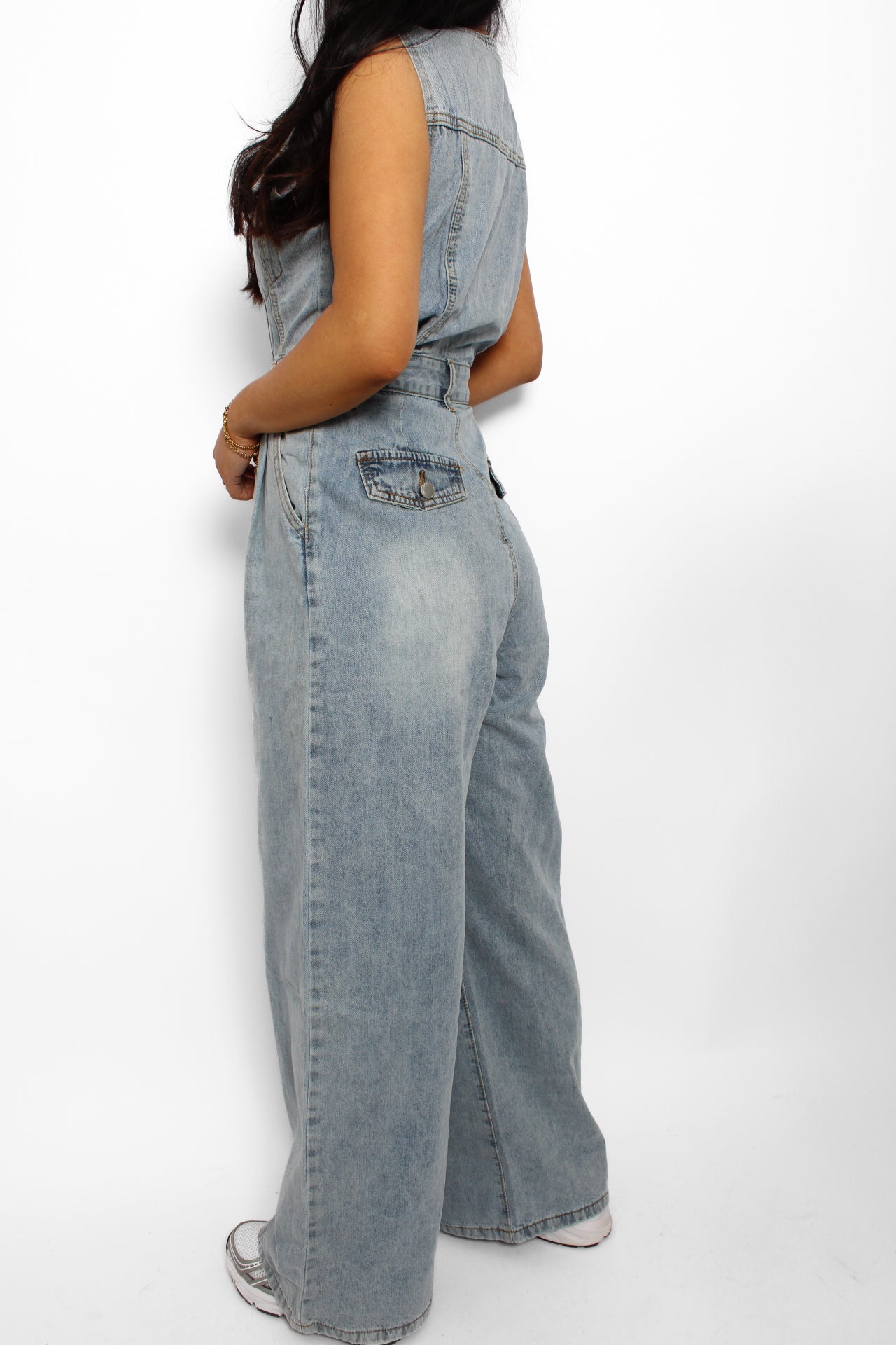en stijlvolle denim jumpsuit met een rechte pasvorm, knoopsluiting aan de voorkant en een tailleband voor extra vorm. De jumpsuit heeft korte mouwen en is gemaakt van een middelzware denim stof, ideaal voor een casual en tijdloze look.