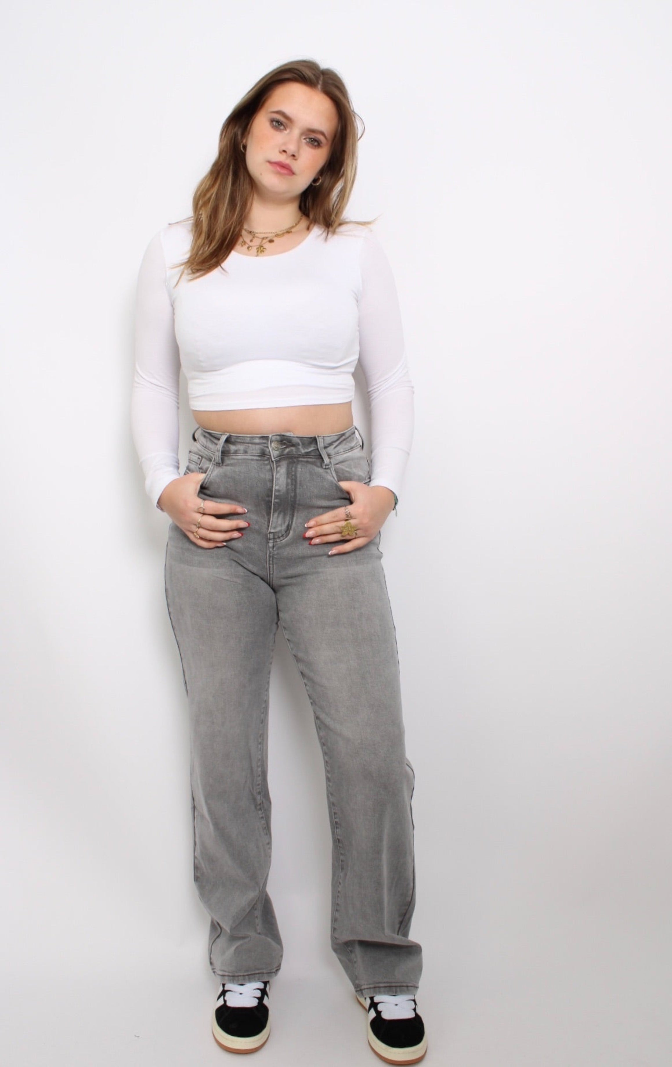 Plus-size lichtgrijze jeans met een frisse, eigentijdse uitstraling. De jeans heeft een flatterende, rechte pasvorm en een subtiele, gewassen look. Het rekbare materiaal biedt zowel comfort als stijl, perfect voor een casual dagoutfit.