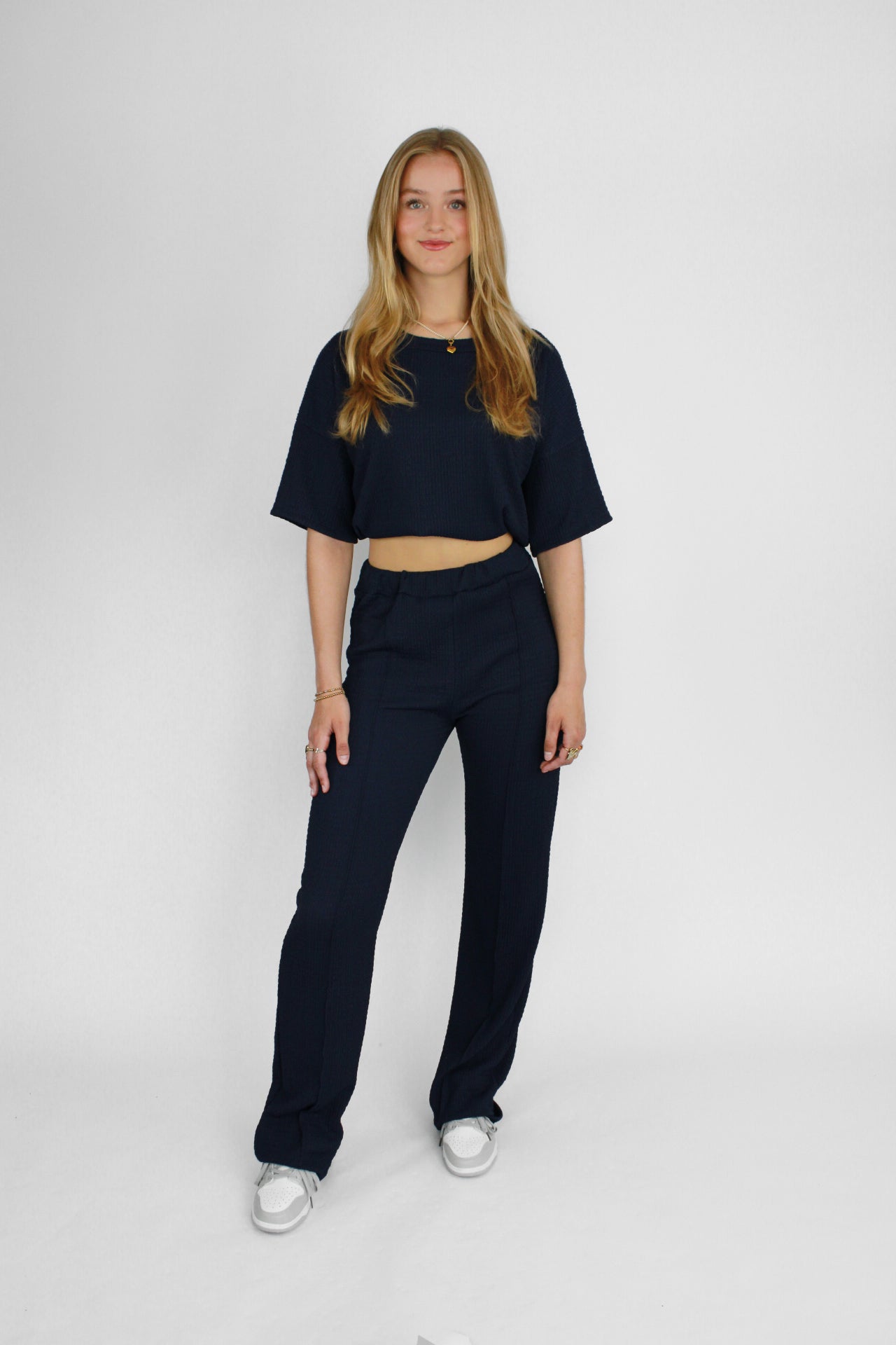 Zomerse outfit voor lange vrouwen: lichte top met een wijde, lange broek die goed past bij langere benen